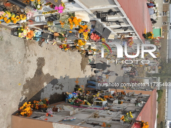 People decorate the graves of their loved ones with cempasuchil flowers at the Municipal Cemetery of San Juan del Rio. Mexicans visit the ce...