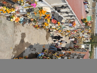 People decorate the graves of their loved ones with cempasuchil flowers at the Municipal Cemetery of San Juan del Rio. Mexicans visit the ce...