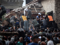 Palestinians scramble to receive sacks of flour at a United Nations Relief and Works Agency (UNRWA) aid distribution center amid the Israel-...