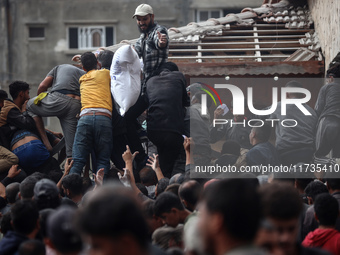 Palestinians scramble to receive sacks of flour at a United Nations Relief and Works Agency (UNRWA) aid distribution center amid the Israel-...