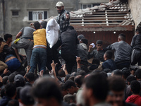 Palestinians scramble to receive sacks of flour at a United Nations Relief and Works Agency (UNRWA) aid distribution center amid the Israel-...