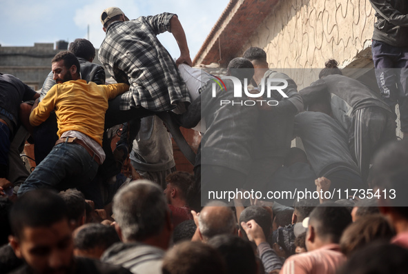 Palestinians scramble to receive sacks of flour at a United Nations Relief and Works Agency (UNRWA) aid distribution center amid the Israel-...