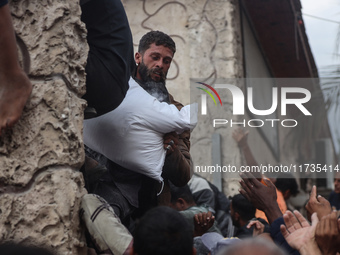 Palestinians scramble to receive sacks of flour at a United Nations Relief and Works Agency (UNRWA) aid distribution center amid the Israel-...