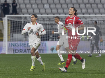 Milan Djuric and Tijjani Reijnders play during the Serie A match between AC Monza and AC Milan at U-Power Stadium in Monza, Italy, on Novemb...