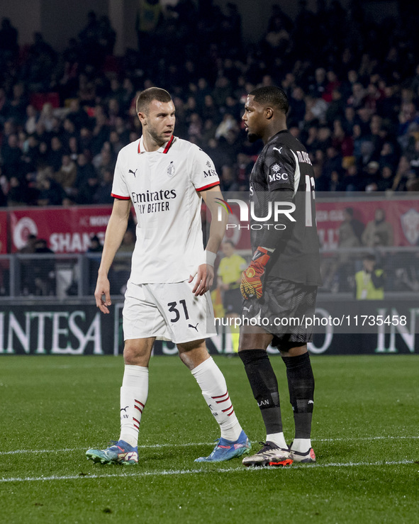 Strahinja Pavlovic and Mike Maignan are in action during the Serie A match between AC Monza and AC Milan at U-Power Stadium in Monza, Italy,...