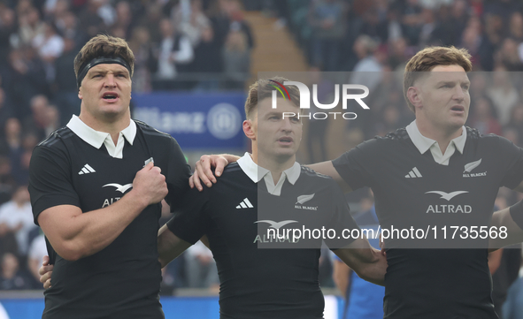 From left to right, Scott Barrett of New Zealand, Beauden Barrett of New Zealand, and Jordie Barrett of New Zealand (brothers) stand before...