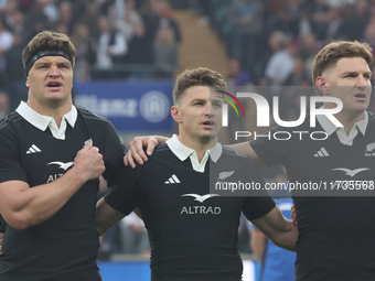 From left to right, Scott Barrett of New Zealand, Beauden Barrett of New Zealand, and Jordie Barrett of New Zealand (brothers) stand before...