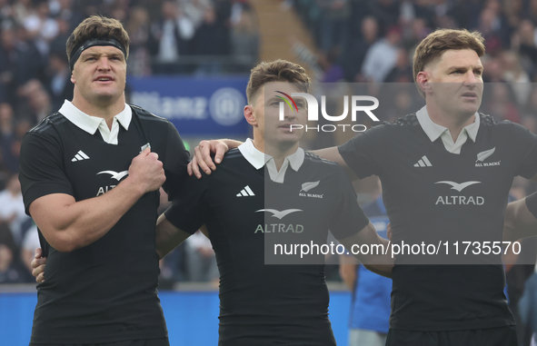 From left to right, Scott Barrett of New Zealand, Beauden Barrett of New Zealand, and Jordie Barrett of New Zealand (brothers) stand before...