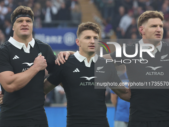 From left to right, Scott Barrett of New Zealand, Beauden Barrett of New Zealand, and Jordie Barrett of New Zealand (brothers) stand before...