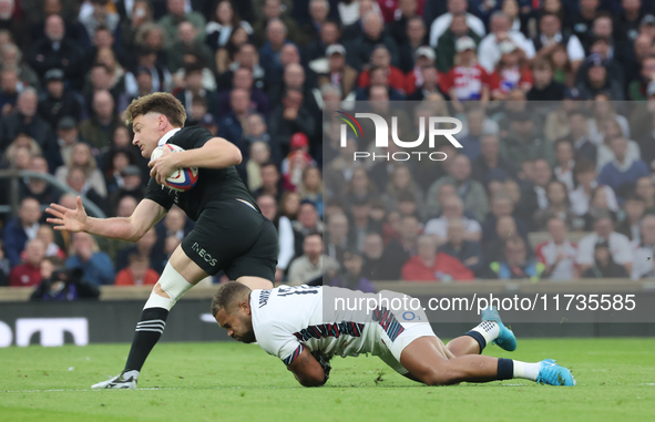 England's Ollie Lawrence (Bath Rugby) tackles Jordie Barrett of New Zealand during the Autumn Nations Series International Rugby match betwe...