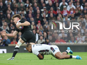 England's Ollie Lawrence (Bath Rugby) tackles Jordie Barrett of New Zealand during the Autumn Nations Series International Rugby match betwe...