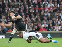 England's Ollie Lawrence (Bath Rugby) tackles Jordie Barrett of New Zealand during the Autumn Nations Series International Rugby match betwe...