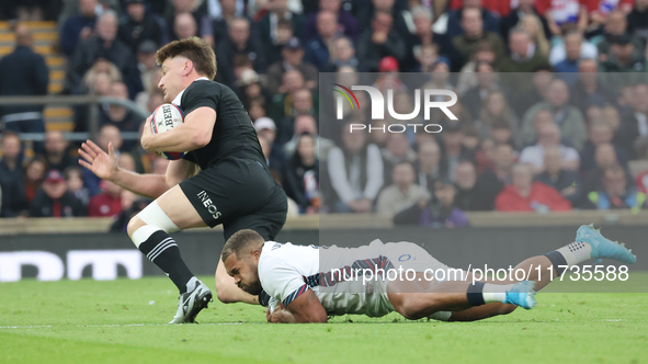 England's Ollie Lawrence (Bath Rugby) tackles Jordie Barrett of New Zealand during the Autumn Nations Series International Rugby match betwe...