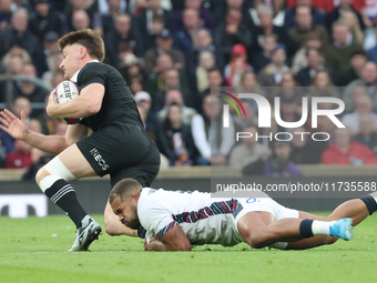 England's Ollie Lawrence (Bath Rugby) tackles Jordie Barrett of New Zealand during the Autumn Nations Series International Rugby match betwe...