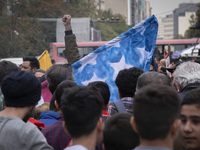 An Iranian student shouts anti-U.S. and anti-Israeli slogans while standing behind the U.S. flag, preparing to set it on fire outside the fo...