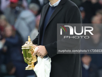 Martin Johnson, former England player, holds the World Cup at halftime during the Autumn Nations Series International Rugby match between En...