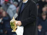 Martin Johnson, former England player, holds the World Cup at halftime during the Autumn Nations Series International Rugby match between En...