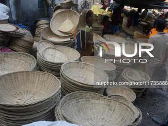 Vendors sell bamboo baskets while devotees and worshipers purchase them at a roadside market for the upcoming Chhath Puja Festival in Siligu...