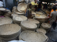 Vendors sell bamboo baskets while devotees and worshipers purchase them at a roadside market for the upcoming Chhath Puja Festival in Siligu...