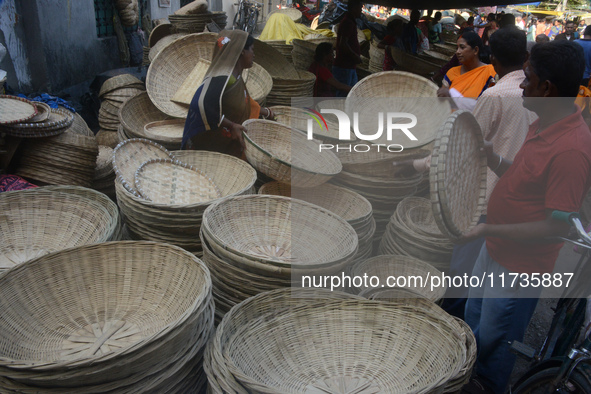 Vendors sell bamboo baskets while devotees and worshipers purchase them at a roadside market for the upcoming Chhath Puja Festival in Siligu...