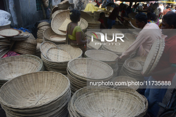 Vendors sell bamboo baskets while devotees and worshipers purchase them at a roadside market for the upcoming Chhath Puja Festival in Siligu...