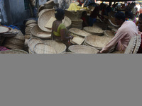 Vendors sell bamboo baskets while devotees and worshipers purchase them at a roadside market for the upcoming Chhath Puja Festival in Siligu...