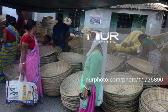 Vendors sell bamboo baskets while devotees and worshipers purchase them at a roadside market for the upcoming Chhath Puja Festival in Siligu...