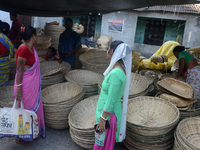 Vendors sell bamboo baskets while devotees and worshipers purchase them at a roadside market for the upcoming Chhath Puja Festival in Siligu...