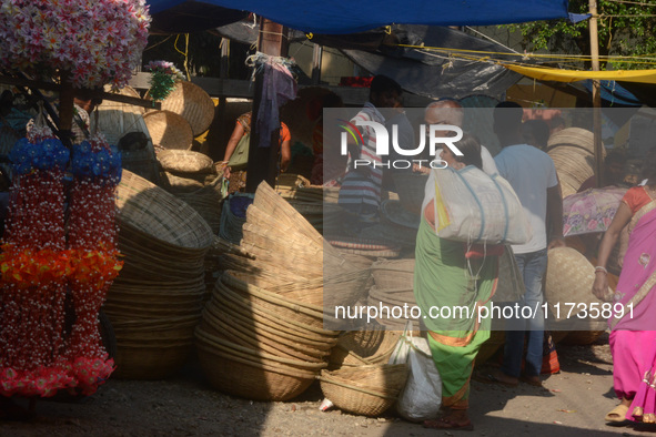 Vendors sell bamboo baskets while devotees and worshipers purchase them at a roadside market for the upcoming Chhath Puja Festival in Siligu...