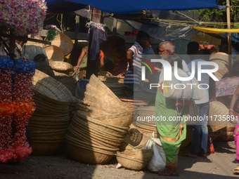 Vendors sell bamboo baskets while devotees and worshipers purchase them at a roadside market for the upcoming Chhath Puja Festival in Siligu...