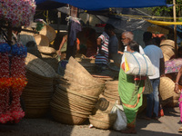 Vendors sell bamboo baskets while devotees and worshipers purchase them at a roadside market for the upcoming Chhath Puja Festival in Siligu...