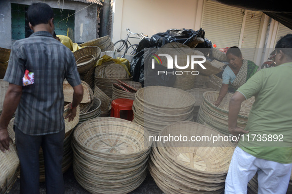 Vendors sell bamboo baskets while devotees and worshipers purchase them at a roadside market for the upcoming Chhath Puja Festival in Siligu...