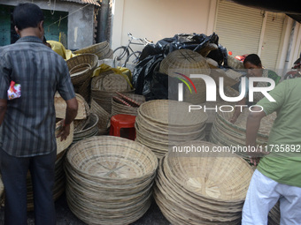 Vendors sell bamboo baskets while devotees and worshipers purchase them at a roadside market for the upcoming Chhath Puja Festival in Siligu...