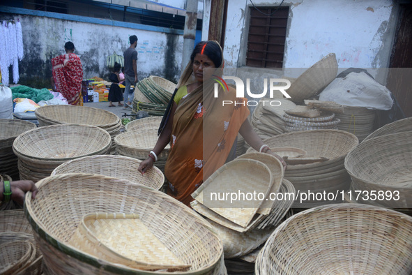 Vendors sell bamboo baskets while devotees and worshipers purchase them at a roadside market for the upcoming Chhath Puja Festival in Siligu...