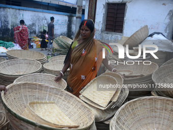 Vendors sell bamboo baskets while devotees and worshipers purchase them at a roadside market for the upcoming Chhath Puja Festival in Siligu...