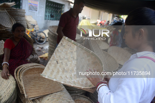 Vendors sell bamboo baskets while devotees and worshipers purchase them at a roadside market for the upcoming Chhath Puja Festival in Siligu...