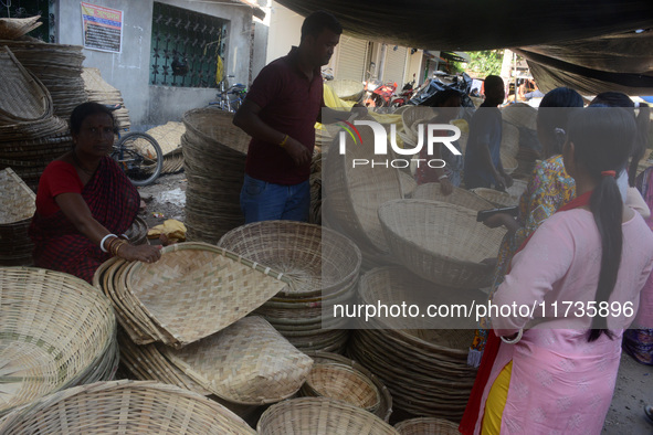 Vendors sell bamboo baskets while devotees and worshipers purchase them at a roadside market for the upcoming Chhath Puja Festival in Siligu...