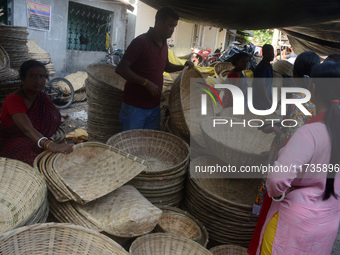 Vendors sell bamboo baskets while devotees and worshipers purchase them at a roadside market for the upcoming Chhath Puja Festival in Siligu...