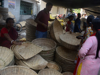 Vendors sell bamboo baskets while devotees and worshipers purchase them at a roadside market for the upcoming Chhath Puja Festival in Siligu...