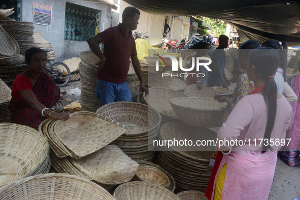 Vendors sell bamboo baskets while devotees and worshipers purchase them at a roadside market for the upcoming Chhath Puja Festival in Siligu...