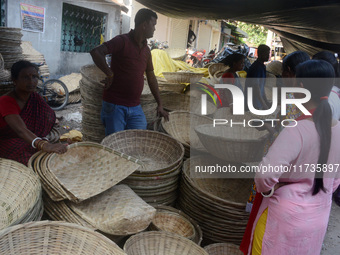 Vendors sell bamboo baskets while devotees and worshipers purchase them at a roadside market for the upcoming Chhath Puja Festival in Siligu...