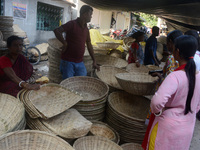 Vendors sell bamboo baskets while devotees and worshipers purchase them at a roadside market for the upcoming Chhath Puja Festival in Siligu...