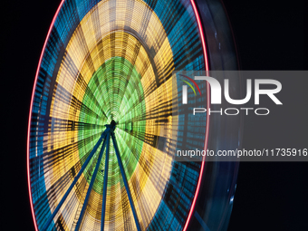 A long exposure captures a Ferris wheel in Orlando, Florida, USA. (