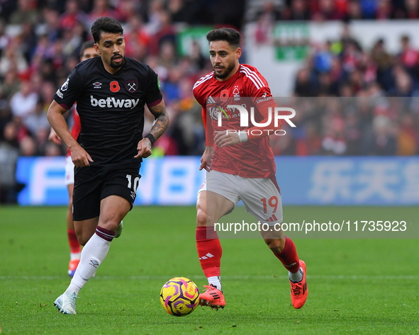 Alex Moreno of Nottingham Forest is under pressure from Lucas Paqueta of West Ham United during the Premier League match between Nottingham...