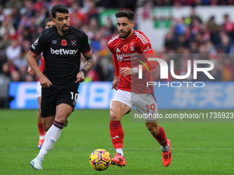 Alex Moreno of Nottingham Forest is under pressure from Lucas Paqueta of West Ham United during the Premier League match between Nottingham...