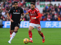 Alex Moreno of Nottingham Forest is under pressure from Lucas Paqueta of West Ham United during the Premier League match between Nottingham...