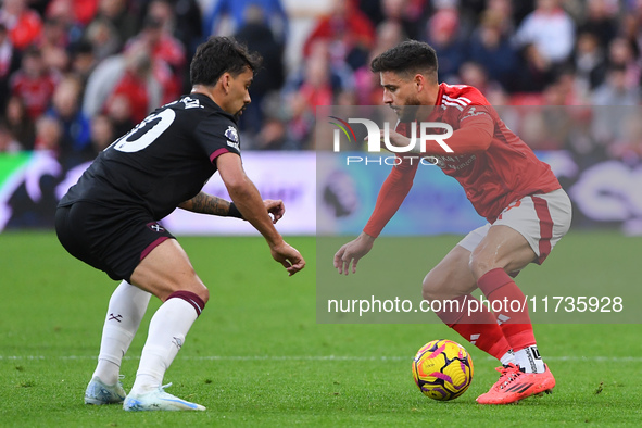 Lucas Paqueta of West Ham United and Alex Moreno of Nottingham Forest participate in the Premier League match between Nottingham Forest and...