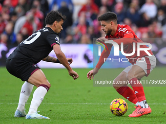 Lucas Paqueta of West Ham United and Alex Moreno of Nottingham Forest participate in the Premier League match between Nottingham Forest and...