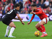 Lucas Paqueta of West Ham United and Alex Moreno of Nottingham Forest participate in the Premier League match between Nottingham Forest and...