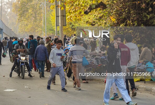 Civilians walk near the site of a grenade blast at a marketplace in Srinagar, Jammu and Kashmir, on November 3, 2024. At least ten people ar...